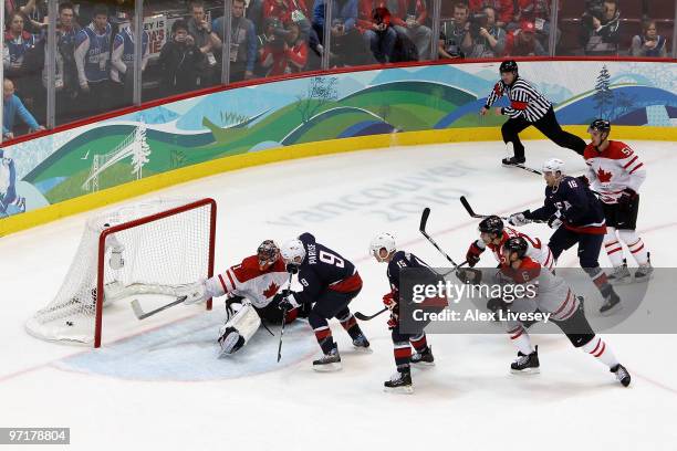 Zach Parise of the United States shoots the puck past Roberto Luongo of Canada late in third period to tie the game 2-2 during the ice hockey men's...