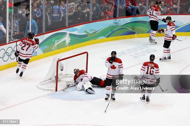 Dejected Team Canada players look on after Zach Parise of the United States scores a goal to tie the scores 2-2 late in the third during the ice...