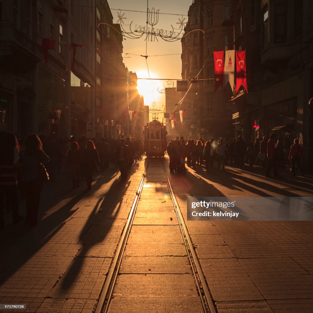 Crowds of shoppers and a tram on Istiklal Avenue in Istanbul, Turkey