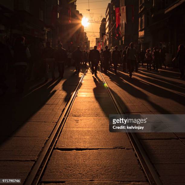crowds of shoppers and a tram on istiklal avenue in istanbul, turkey - kelvinjay stock pictures, royalty-free photos & images