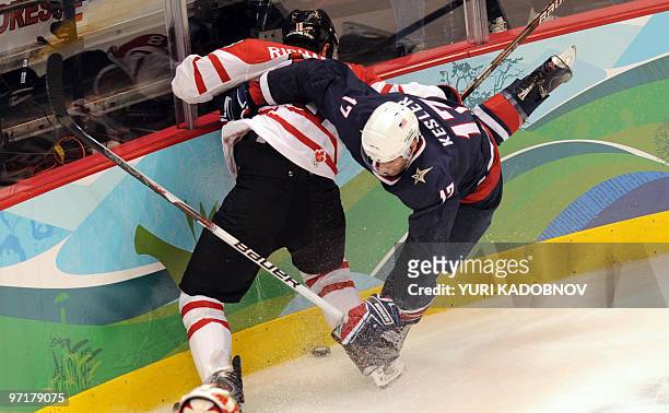 Canadian forward Michael Richards and USA's forward Ryan Kesler vie for the puck during the Men's Gold Medal Hockey match between USA and Canada at...