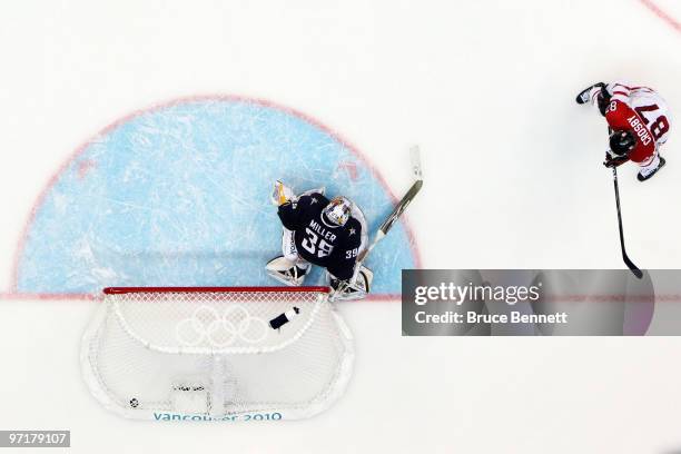 Sidney Crosby of Canada scores the matchwinning goal in overtime past Ryan Miller of the United States during the ice hockey men's gold medal game...