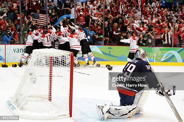 Sidney Crosby of Canada celebrates after scoring the matchwinning goal in overtime whilst a dejected Ryan Miller of the United States looks on during...