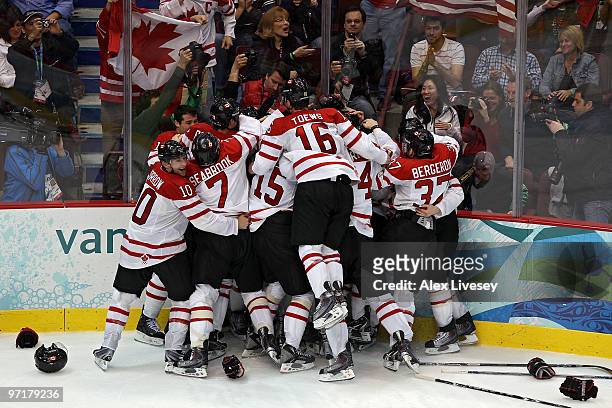Team Canada celebrate after Sidney Crosby of Canada scores the matchwinning goal in overtime during the ice hockey men's gold medal game between USA...