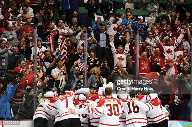 Team Canada celebrate after Sidney Crosby of Canada scores the matchwinning goal in overtime during the ice hockey men's gold medal game between USA...