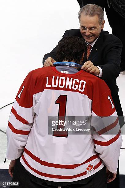 Roberto Luongo of Canada is presented his gold medal by IOC President Jacques Rogge following his team's 3-2 overtime win during the ice hockey men's...