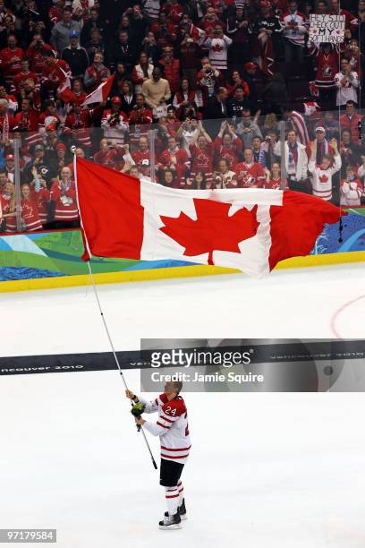Corey Perry of Canada celebrates with the flag after winning the gold medal in the ice hockey men's gold medal game between USA and Canada on day 17...