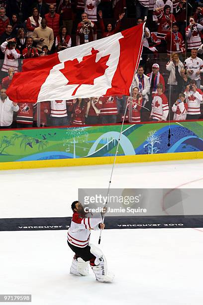 Roberto Luongo of Canada celebrates with the flag after winning the gold medal in the ice hockey men's gold medal game between USA and Canada on day...
