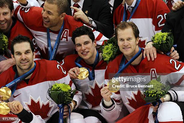 Dan Boyle, Sidney Crosby and Chris Pronger of Canada celebrate with the gold medals won during the ice hockey men's gold medal game between USA and...