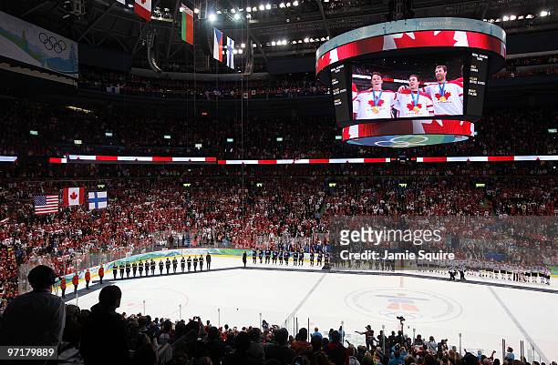 Team Canada receive the gold medals won following their 3-2 overtime victory during the ice hockey men's gold medal game between USA and Canada on...