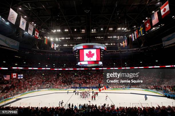 Team Canada celebrate after receiving their gold medals following their 3-2 overtime victory during the ice hockey men's gold medal game between USA...