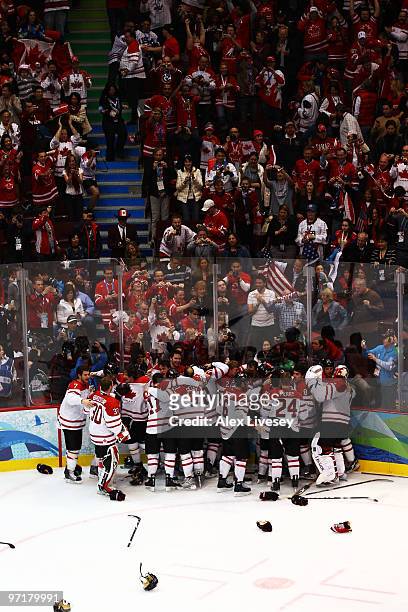 Team Canada celebrate after Sidney Crosby of Canada scores the matchwinning goal in overtime during the ice hockey men's gold medal game between USA...