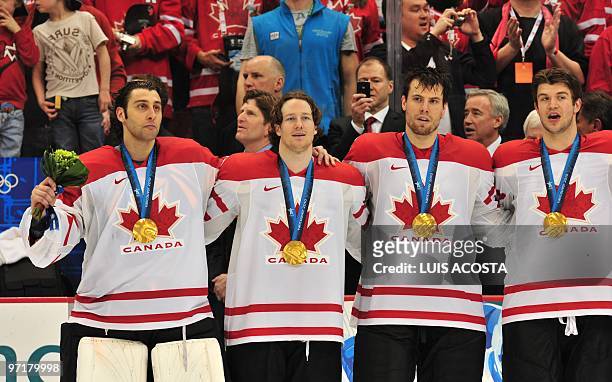 Canada's players react after defeating the US in the men's gold medal Ice Hockey match at Canada Hockey Place during the Vancouver Winter Olympics in...