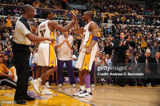 Ron Artest and Kobe Bryant of the Los Angeles Lakers bump hands during a game against the Denver Nuggets at Staples Center on February 28, 2010 in...