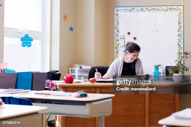 teacher in a classroom without students at school's out. - board eraser stock pictures, royalty-free photos & images