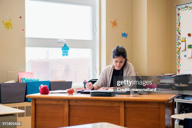 teacher in a classroom without students at school's out. - board eraser stock pictures, royalty-free photos & images