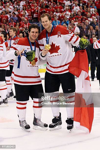 Michael Richards and Chris Pronger of Canada celebrate after receiving the gold medals won during the ice hockey men's gold medal game between USA...