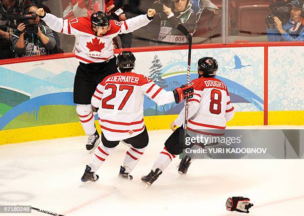 Canadian forward Sidney Crosby celebrates with teammates Scott Niedermayer and Drew Doughty as Canada's team win gold during the Men's Gold Medal...