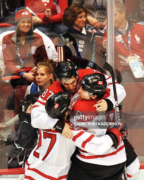 Canadian forward Sidney Crosby celebrates with teammates Scott Niedermayer and Drew Doughty as Canada's team win gold during the Men's Gold Medal...