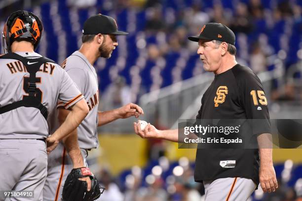 Manager Bruce Bochy of the San Francisco Giants takes the baseball from Madison Bumgarner during a pitching change in the sixth inning of the game...