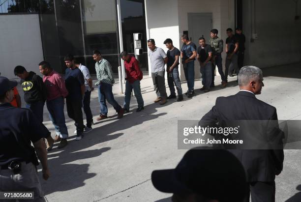 Undocumented immigrants leave a U.S. Federal court in shackles on June 11, 2018 in McAllen, Texas. Thousands of migrants continue to cross into the...