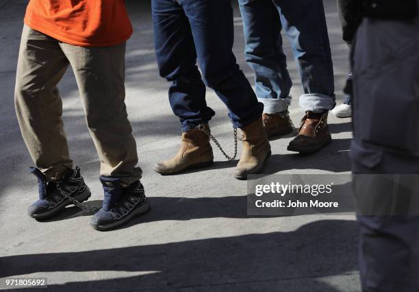 Undocumented immigrants leave a U.S. Federal court in shackles on June 11, 2018 in McAllen, Texas. Thousands of migrants continue to cross into the...