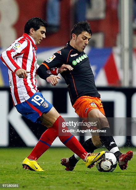 David Villa of Valencia competes for a ball with Jose Antonio Reyes of Atletico Madrid during the La Liga match between Atletico Madrid and Valencia...