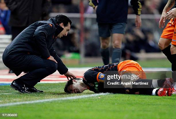 Head coach Unay Emery of Valencia comforts his player David Villa after receives a faul during the La Liga match between Atletico Madrid and Valencia...