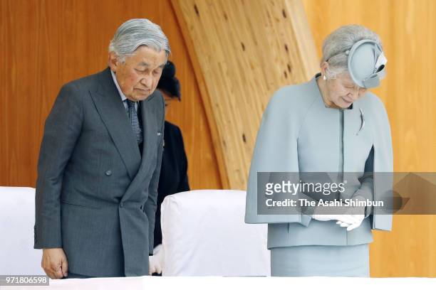Emperor Akihito and Empress Michiko observe a minute of silence for the victims of the Great East Japan Earthquake during the National Tree-Planting...