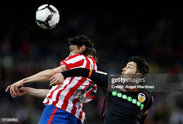David Villa of Valencia fights for the ball with Thomas Ujfalusi of Atletico Madrid during the La Liga match between Atletico Madrid and Valencia at...