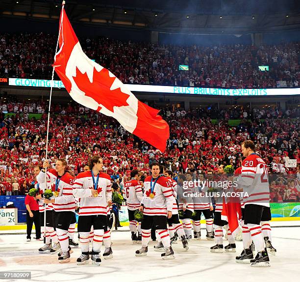 Canada's players react after defeating the US in the men's gold medal Ice Hockey match at Canada Hockey Place during the Vancouver Winter Olympics in...