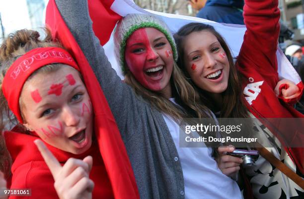 Team Canada hockey fans celebrate at Robson and Burrard Streets following Canada's 3-2 overtime victory over the USA to win the ice hockey men's gold...