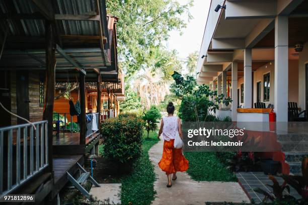 young woman walking on the island of koh lanta, thailand - bungalow stock pictures, royalty-free photos & images