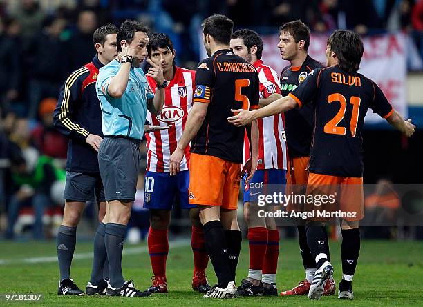 Carlos Marchena of Valencia argues with referee Alfonso Perez Burrull during the La Liga match between Atletico Madrid and Valencia at Vicente...