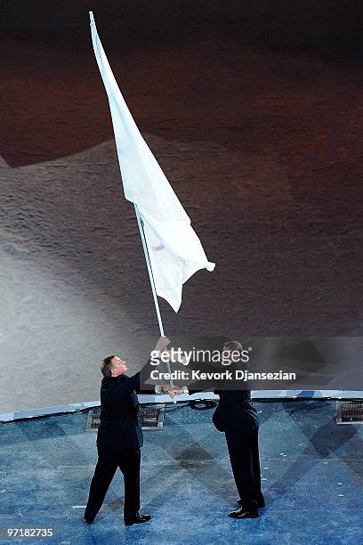 President Jacques Rogge passes the Olympic flag to Mayor of Sochi Anatoly Pakhomov during the Closing Ceremony of the Vancouver 2010 Winter Olympics...
