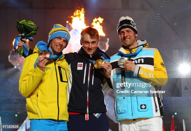 Axel Teichmann of Germany receives the silver medal, Petter Northug of Norway receives the gold medal and Johan Olsson of Sweden receives the bronze...