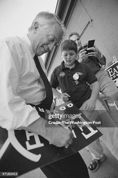 Day in the life of the campaign trail with Mark Earley. This is Earley sigining a poster for a your supporter outside the Newport News Shipbuilding...