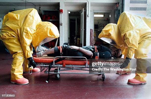 Howard County firefighters in Hazmat suits. PICTURED, Medical Duty Officer Lt. Charles T. King and Lt. John Zimmerman are going through "suit...
