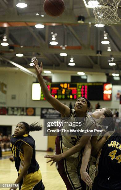 Sp-mdgirls14 Catonsville, Md Mark Gail_TWP Paint Branch's Ashley Alexander watchs her shot go up over Gwynn Park defenders in the Class 3A finals at...