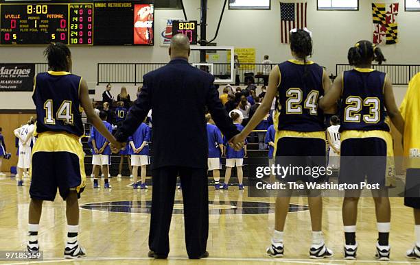 Sp-mdgirls14 Catonsville, Md Mark Gail_TWP Potomac's players and head coach Micheal Strother joins hand during the plaing of the national anthem...