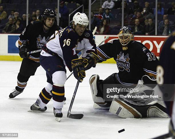 Caps21 Kevin Clark\The Washington Post Date: 3.20.2004 Neg #: 153423 MCI Center, Washington, DC. Ronald Petrovicky of the Thrashers attempts a shot...