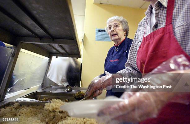 Mx-flavor27 11-19-03 Mark Gail_TWP Jeanne Mc Coy waits for Melissa Middleton to spoon a serving of rice on a plate to be served at dinner at the...