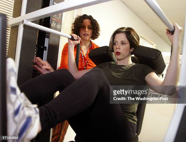 Heather Miller Podesta, of Blank Rome Government Relations, trains on exercise machines using a slow repetition technique with trainer Karen...