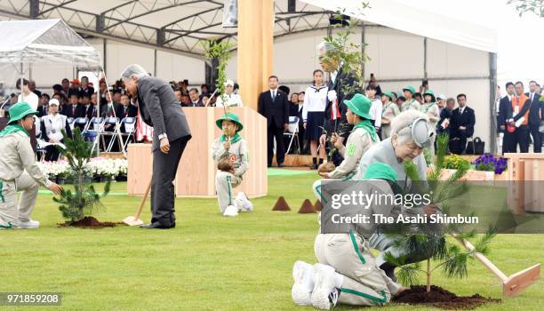 Emperor Akihito and Empress Michiko plant young trees during the National Tree-Planting Festival on June 10, 2018 in Minamisoma, Fukushima, Japan....