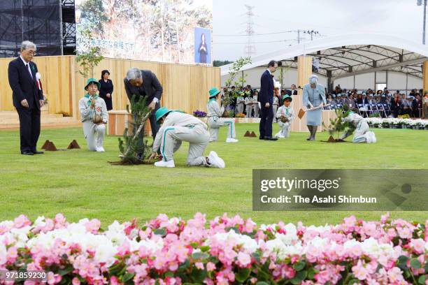 Emperor Akihito and Empress Michiko plant young trees during the National Tree-Planting Festival on June 10, 2018 in Minamisoma, Fukushima, Japan....