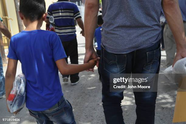 Central American immigrant families depart ICE custody, pending future immigration court hearings on June 11, 2018 in McAllen, Texas. Thousands of...