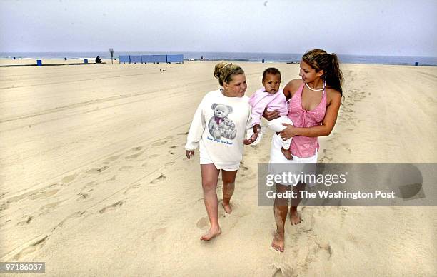 Me-beach28 5/27/04 Ocean City, Md. Mark Gail_TWP left to right, Gia Lewis, Layla and Zoe Sabotta all from Bear, Delaware enjoy a walk on a near empty...