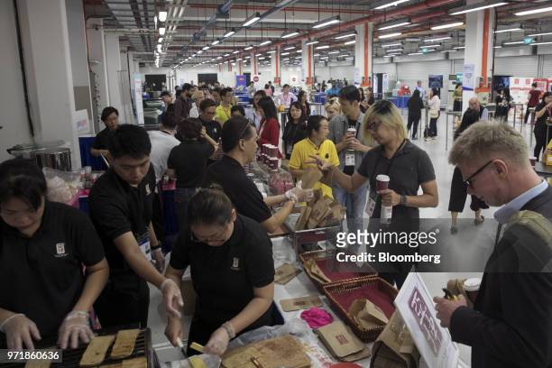 Members of the media collect coffee and food inside the media center for the DPRK-USA Singapore Summit in Singapore, on Tuesday, June 12, 2018....