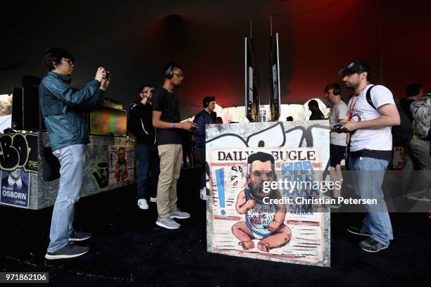 Game enthusiasts and industry personnel test 'Marvel Spiderman' during the Sony Playstation E3 conference at LA Center Studios on June 11, 2018 in...