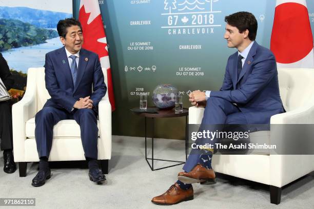 Japanese Prime Minister Shinzo Abe and Canadian Prime Minister Justin Trudeau talk during their bilateral meeting on the sidelines of the G7 Summit...